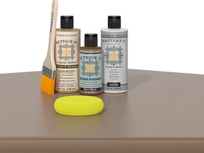 Retique It Barn Wood Kit with Light Wood Wood'n Primer, Barn Wood Gel Stain Alternative, Satin Polytique It topcoat, paintbrush, and yellow sponge on a tabletop.