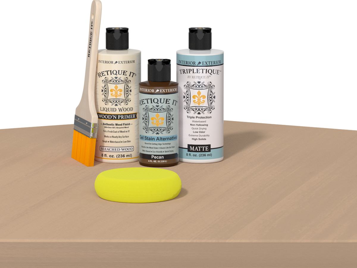 Retique It® Pecan Multipurpose Kit contents with Bleached Wood Liquid Wood primer, Pecan gel stain alternative, Tripletique matte top coat, paintbrush, and yellow sponge displayed on a light wood surface.
