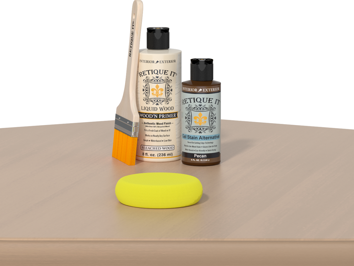Retique It® Pecan Multipurpose Kit contents with Bleached Wood Liquid Wood primer, Pecan gel stain alternative, paintbrush, and yellow sponge displayed on a light wood surface.