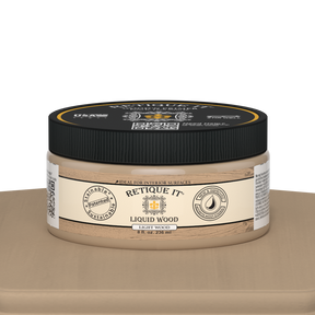 Retique It® Liquid Wood paint jar in light interior finish, 8oz size, displayed on a table with a natural wood-looking appearance.