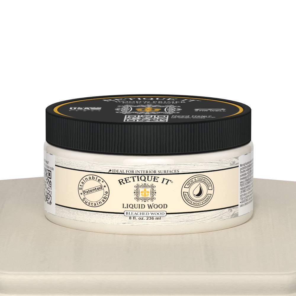 Retique It® Liquid Wood 8oz bleached interior paint jar on table, showing the clear glass container and white liquid inside.