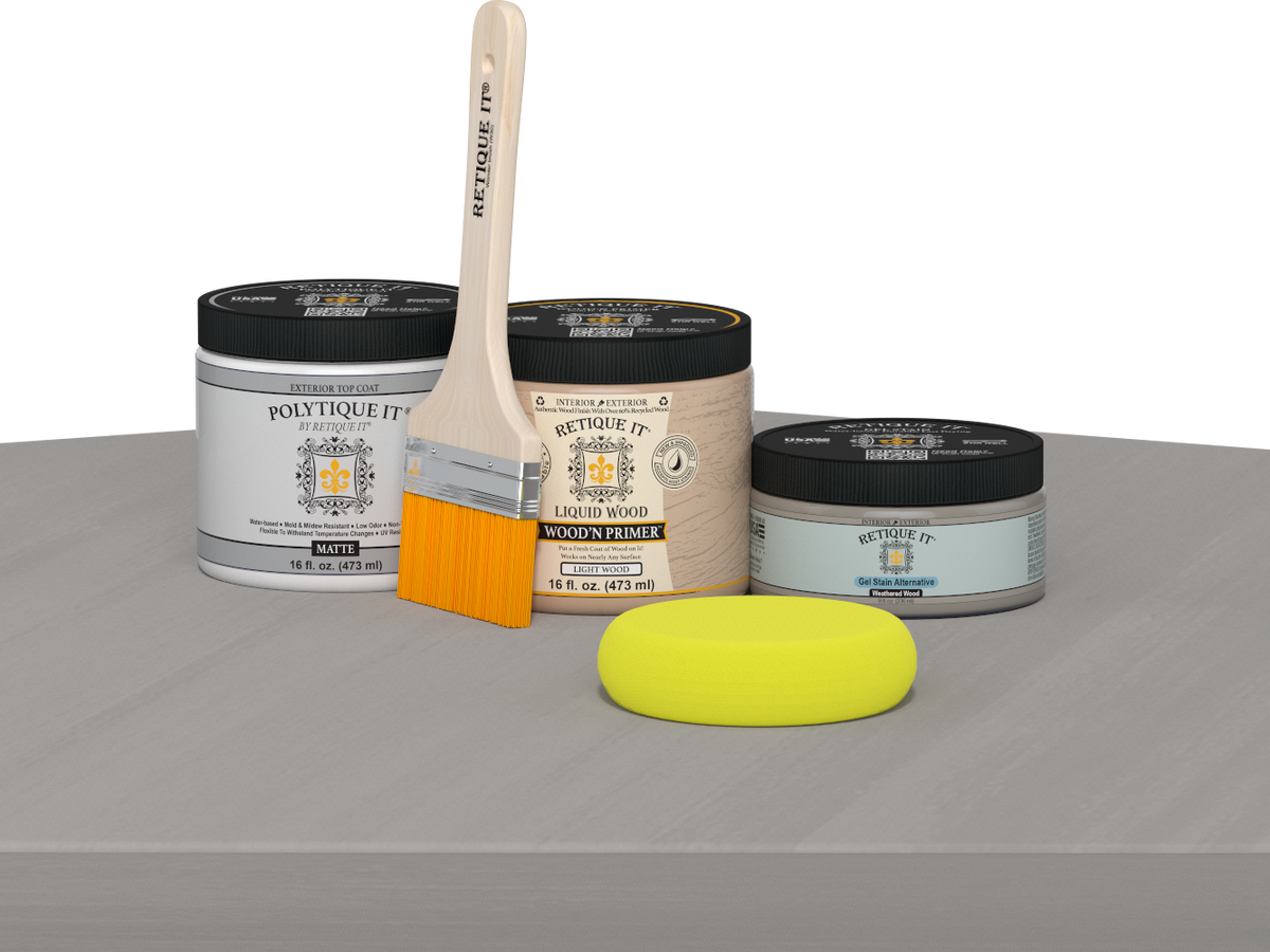 Retique It® Weathered Wood Multipurpose Kit contents with Light Wood Liquid Wood primer, Weathered Wood gel stain alternative, PolyTique It® matte exterior top coat, paintbrush, and yellow sponge displayed on a gray wood surface.