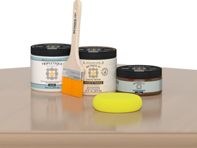 Retique It® White Oak Multipurpose Kit contents with Liquid Wood primer, Pecan gel stain alternative, Tripletique gloss interior top coat, paintbrush, and yellow sponge displayed on a light wood surface.