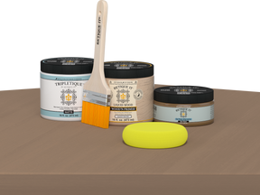 Retique It® Barn Wood Multipurpose Kit contents with Light Wood Liquid Wood primer, Barn Wood gel stain alternative, Tripletique matte interior top coat, paintbrush, and yellow sponge displayed on a wood surface.