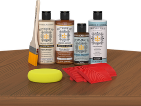 Retique It® Wood'n Finish Kit in Cedar stain displayed on a table, showcasing the wood stain product for furniture finishing.