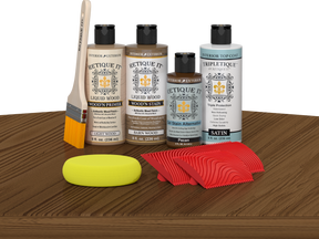 Retique It® Barn Wood Wood'n Kit with Light Wood Primer, Barn Wood Wood'n Stain, Satin TripleTique Top Coat, Pecan Gel Stain Alternative, yellow sponge, red graining tool, and brush.