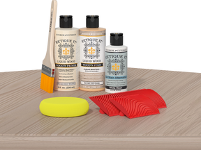 Retique It® Wood'n Finish Kit for fireplaces, Sun Bleached color, showcasing the wood finish applied to a mantel on a table.