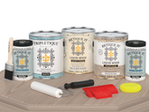 Retique It® Wood'n Kit Multi-purpose wood finish set with four sun-bleached interior top coat bottles on a table.