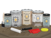 Retique It Wood'n Finish Kit with four weathered wood exterior top coat samples in matte finish on a table.