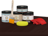 Retique It Wood'n Finish Kit in Red Mahogany stain, double size, with stain bottles and applicator on table surface.