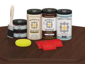 Retique It® Wood'n Finish Kit Java stain on a wooden table top showing a satin finish and four large stain bottles.