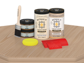 Retique It® Wood'n Cabinet Kit with 12 white oak grained door stains, displayed on a table, showcasing natural wood grain finish.