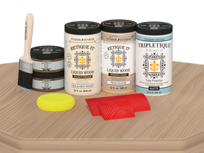 Retique It® Wood'n Finish Kit with four large white oak stain bottles and matte finish, shown on a table surface.