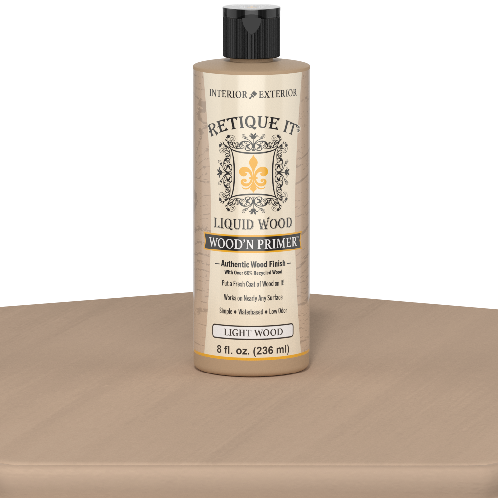 Retique It® Liquid Wood Wood'n Primer in Light Wood, 8 fl oz, showing the primer applied on a wooden table surface.