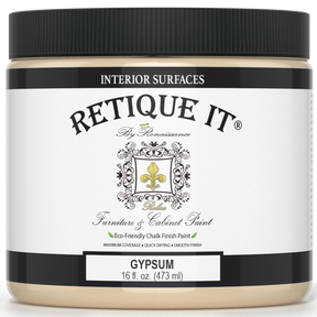 Retique It® furniture and cabinet paint in a quart container, designed for gypsum surfaces, shown in a natural setting.