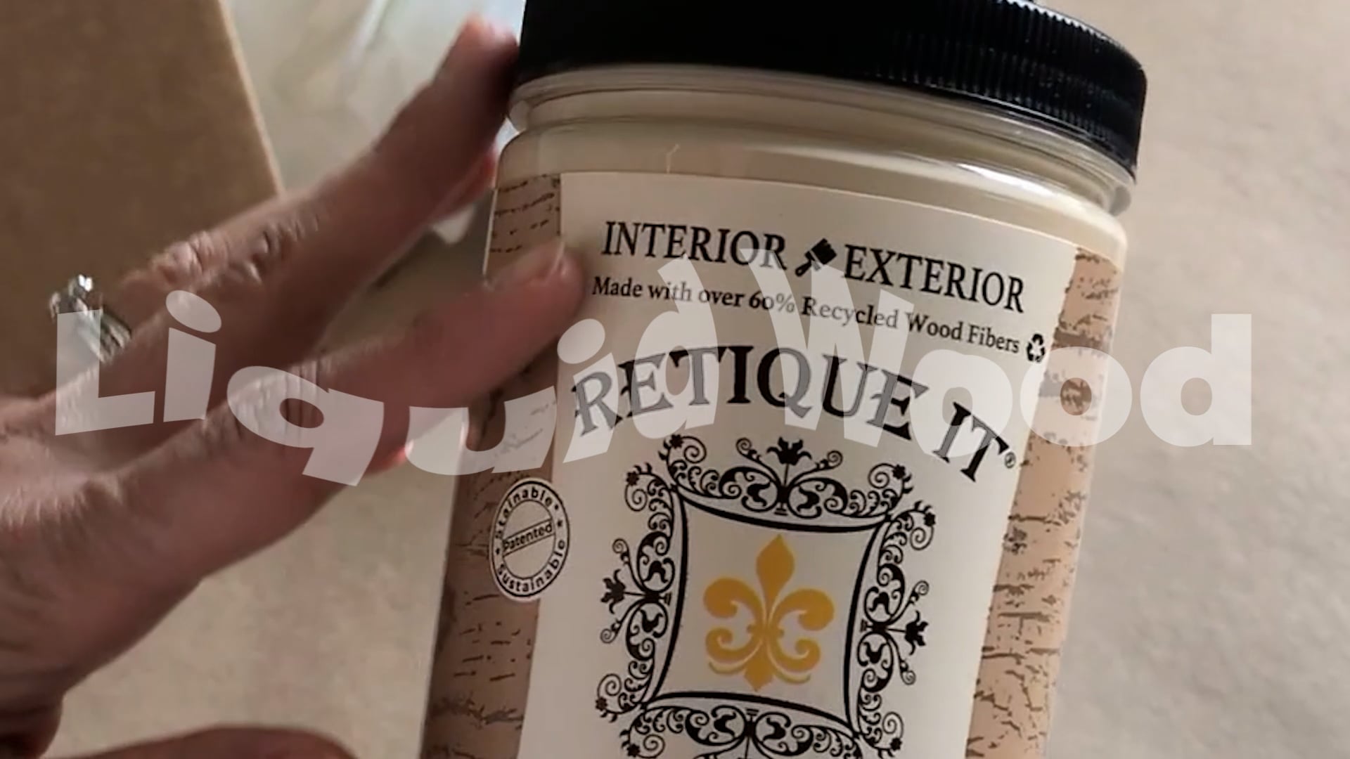 Hand holding a container labeled 'Retique It' with decorative text and branding.